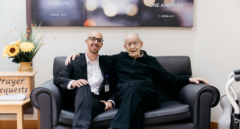 Pastor sitting with senior